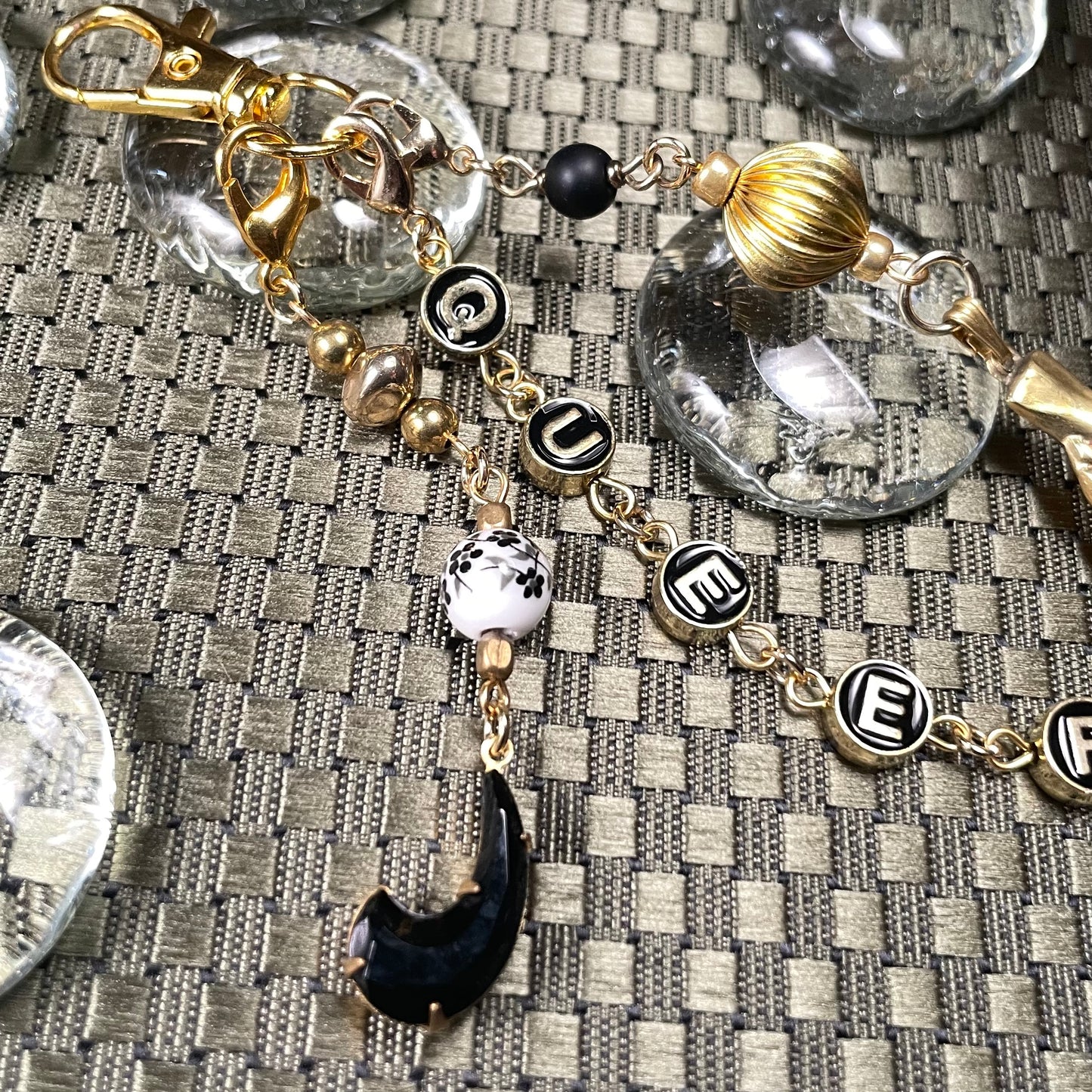 Queer goldtone bag charm