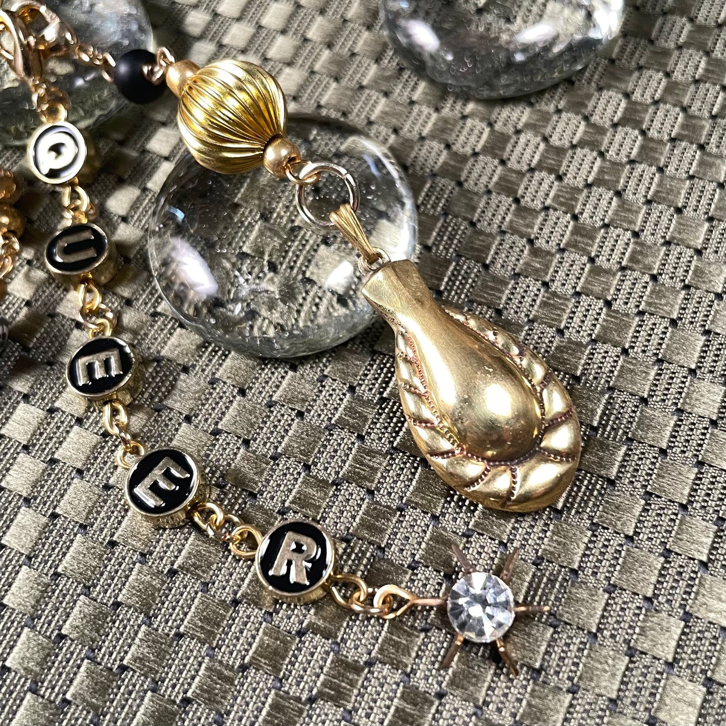 Queer goldtone bag charm