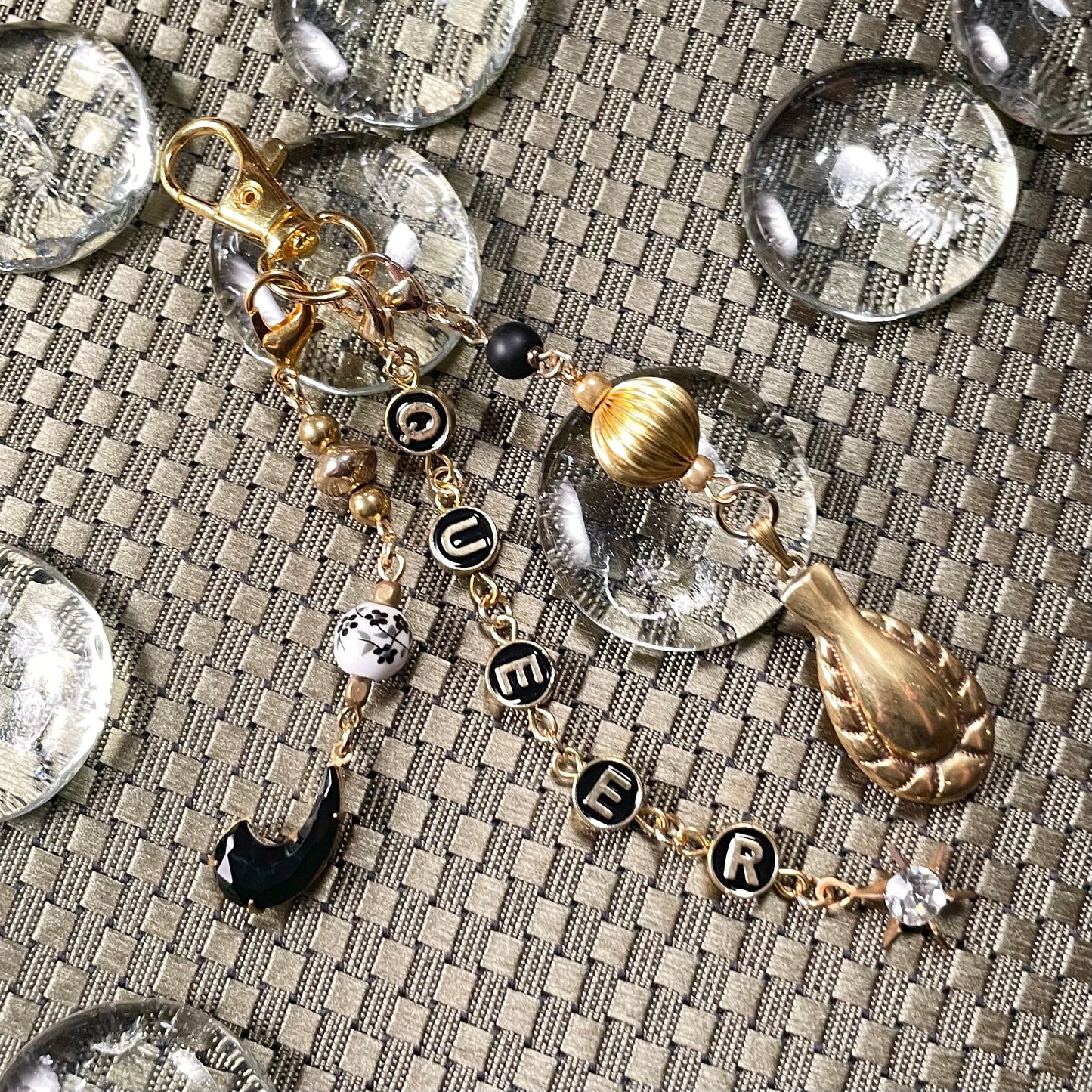 Queer goldtone bag charm