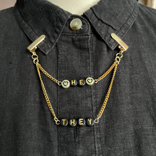 gold "HE/THEY" pronouns clip chain